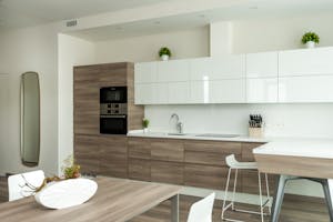 Contemporary kitchen interior with wood cabinets and sleek decor.